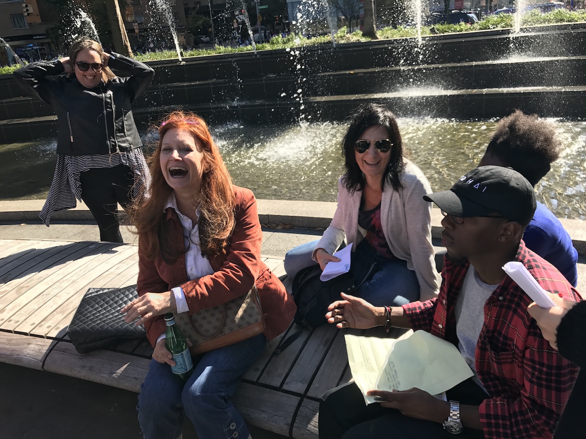 Arts Politics students and Professor Karen Finley laugh in front of foutain